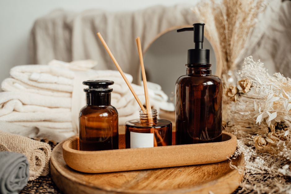 Brown glass bottles and dried botanicals create a serene spa vibe.
